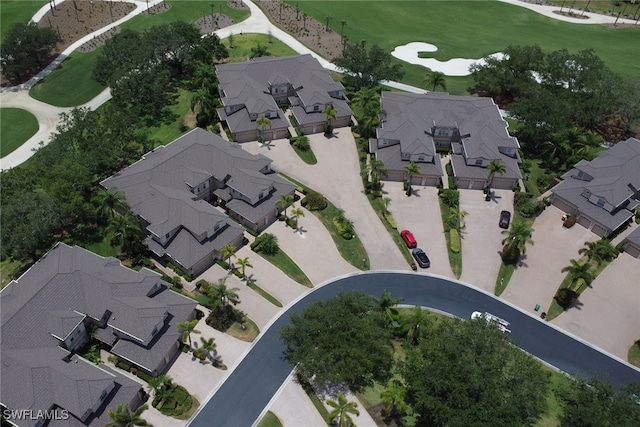 aerial view of property and surrounding area with nearby suburban area and a golf course