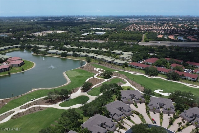 aerial view of property's location featuring a nearby body of water and nearby suburban area