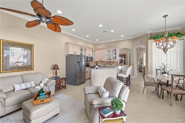 3417 Marbella Ct, Bonita Springs, FL 34134 - living area featuring arched walkways, a chandelier, ornamental molding, recessed lighting, and light tile patterned floors