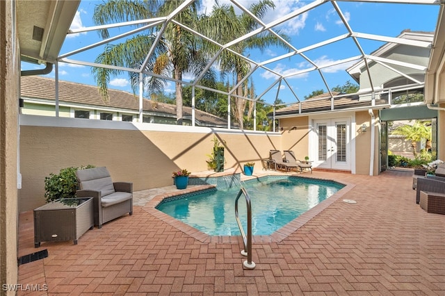 3417 Marbella Ct, Bonita Springs, FL 34134 - swimming pool with french doors, a patio, and glass enclosure