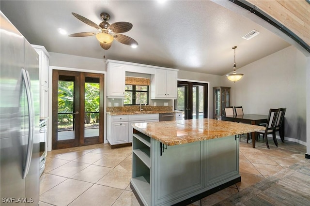 681 23rd St NW, Naples, FL 34120 - kitchen with french doors, stainless steel appliances, a sink, open shelves, and white cabinets
