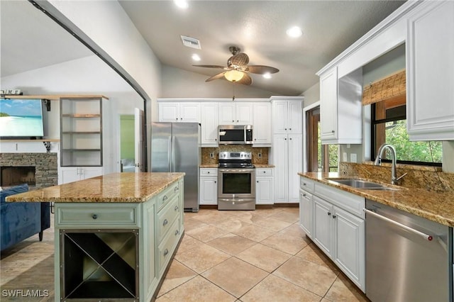 681 23rd St NW, Naples, FL 34120 - kitchen featuring appliances with stainless steel finishes, a sink, lofted ceiling, tasteful backsplash, and a ceiling fan