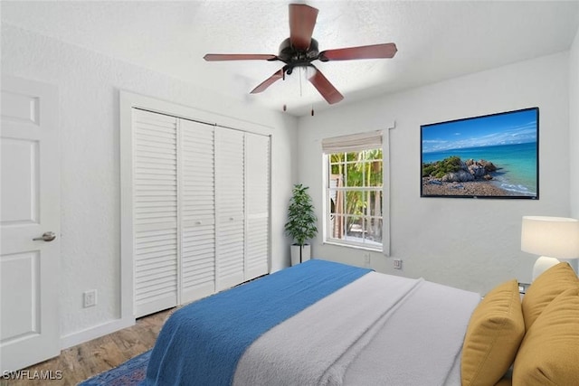 681 23rd St NW, Naples, FL 34120 - bedroom with wood finished floors, a closet, baseboards, and a ceiling fan