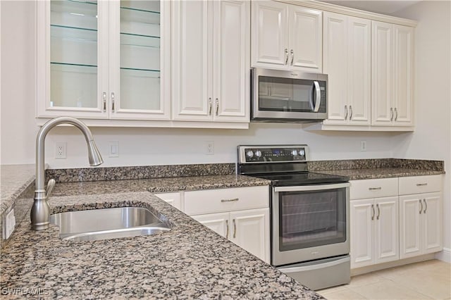 4910 SW 17th Pl Unit 4B, Cape Coral, FL 33914 - kitchen featuring stainless steel appliances, white cabinetry, and dark stone countertops