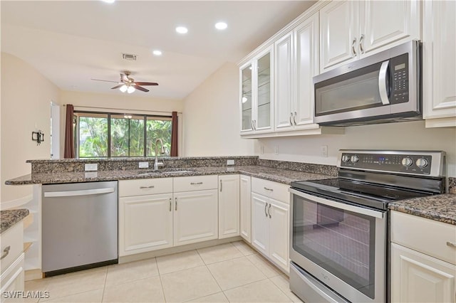 4910 SW 17th Pl Unit 4B, Cape Coral, FL 33914 - kitchen with appliances with stainless steel finishes, a peninsula, white cabinetry, a ceiling fan, and light tile patterned floors