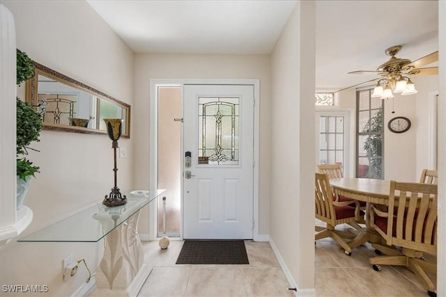 8015 Tiger Cv Unit 204, Naples, FL 34113 - entrance foyer featuring light tile patterned flooring, ceiling fan, and baseboards