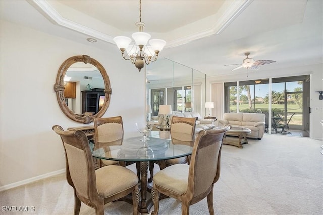8015 Tiger Cv Unit 204, Naples, FL 34113 - dining room featuring a raised ceiling, a chandelier, light colored carpet, ornamental molding, and plenty of natural light