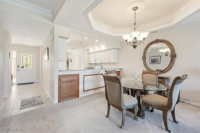8015 Tiger Cv Unit 204, Naples, FL 34113 - dining space featuring a chandelier, baseboards, light colored carpet, ornamental molding, and a tray ceiling