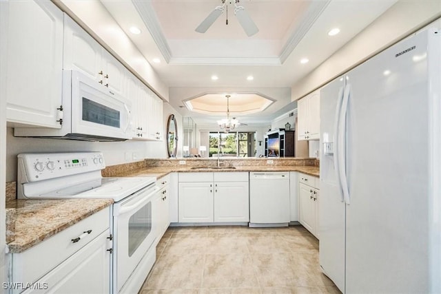 8015 Tiger Cv Unit 204, Naples, FL 34113 - kitchen featuring white appliances, a raised ceiling, a sink, ornamental molding, and a chandelier