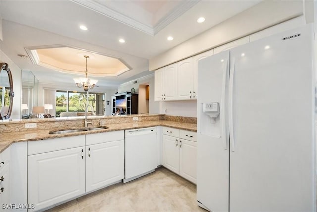 8015 Tiger Cv Unit 204, Naples, FL 34113 - kitchen featuring white appliances, a tray ceiling, a sink, recessed lighting, and ornamental molding