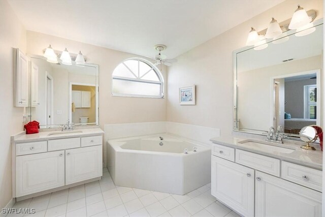 8015 Tiger Cv Unit 204, Naples, FL 34113 - bathroom with healthy amount of natural light, connected bathroom, two vanities, and tile patterned flooring