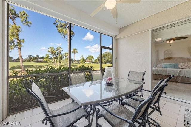8015 Tiger Cv Unit 204, Naples, FL 34113 - sunroom with ceiling fan, golf course view, and outdoor dining space