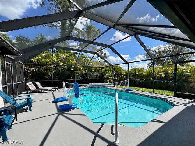 2639 SW 5th St, Cape Coral, FL 33991 - outdoor pool with a patio, glass enclosure, and view of scattered trees