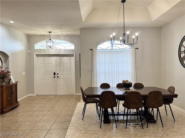 2639 SW 5th St, Cape Coral, FL 33991 - dining area with a chandelier, light tile patterned floors, baseboards, and a textured ceiling