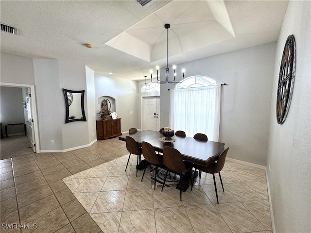 2639 SW 5th St, Cape Coral, FL 33991 - dining space with a chandelier, light tile patterned floors, a tray ceiling, and baseboards