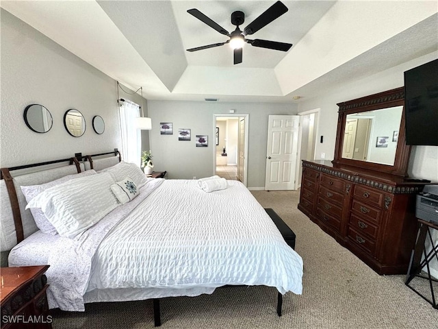 2639 SW 5th St, Cape Coral, FL 33991 - bedroom with a raised ceiling, carpet flooring, ceiling fan, ensuite bath, and baseboards
