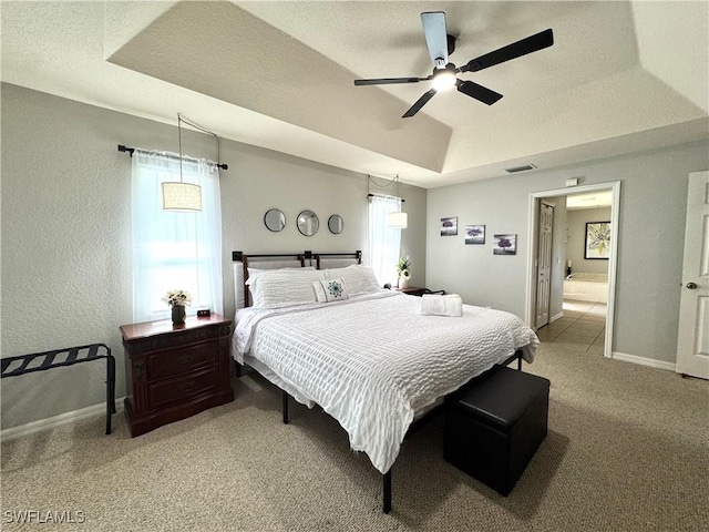 2639 SW 5th St, Cape Coral, FL 33991 - bedroom with light colored carpet, a tray ceiling, baseboards, connected bathroom, and a textured wall
