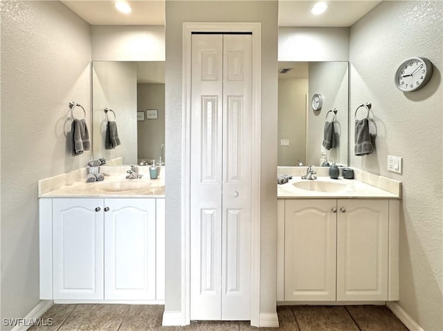 2639 SW 5th St, Cape Coral, FL 33991 - full bathroom with a closet, tile patterned floors, two vanities, and a textured wall