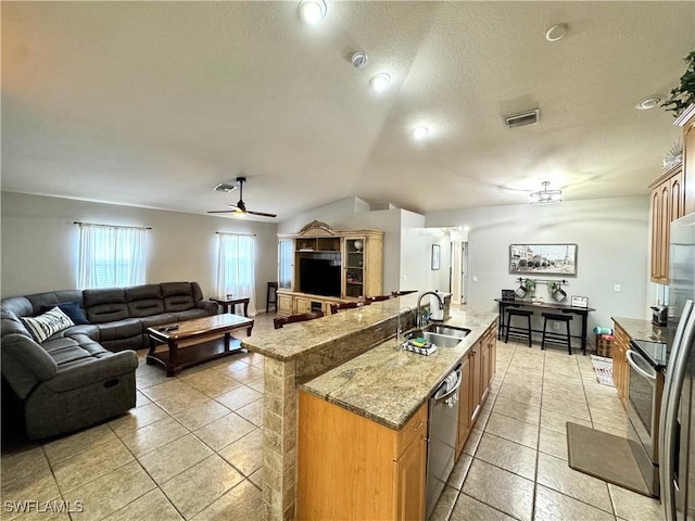 2639 SW 5th St, Cape Coral, FL 33991 - kitchen featuring a sink, open floor plan, lofted ceiling, stainless steel appliances, and a kitchen island with sink