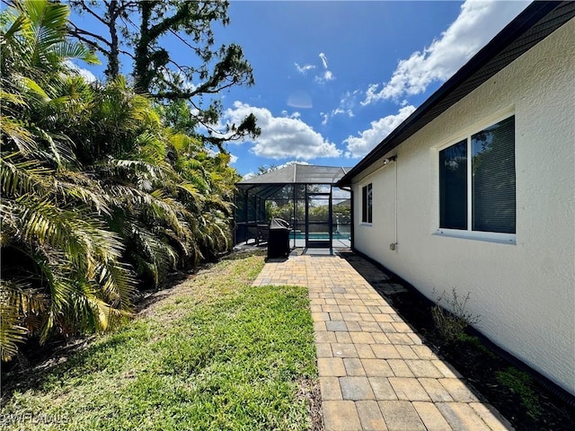 2639 SW 5th St, Cape Coral, FL 33991 - view of green lawn with a patio area, an outdoor pool, and a lanai