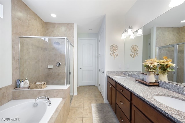 full bath with a stall shower, a bath, double vanity, and tile patterned floors