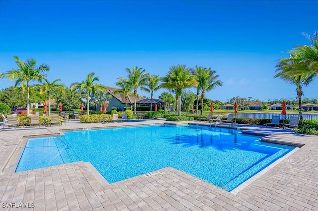 community pool featuring a patio and fence