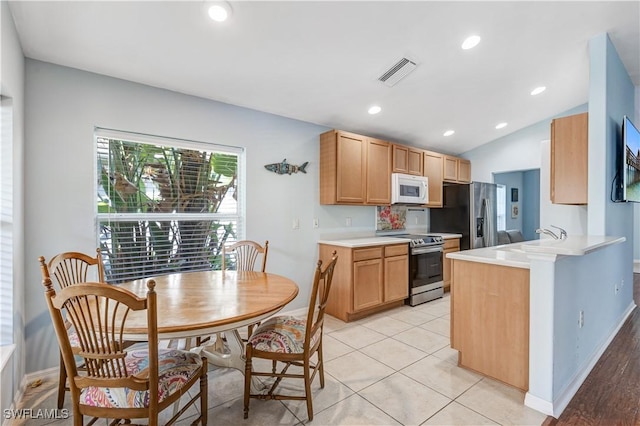 2664 Astwood Ct, Cape Coral, FL 33991 - kitchen featuring appliances with stainless steel finishes, baseboards, a sink, light countertops, and a peninsula