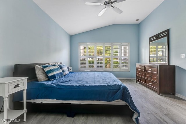 2664 Astwood Ct, Cape Coral, FL 33991 - bedroom with light wood finished floors, multiple windows, vaulted ceiling, and baseboards