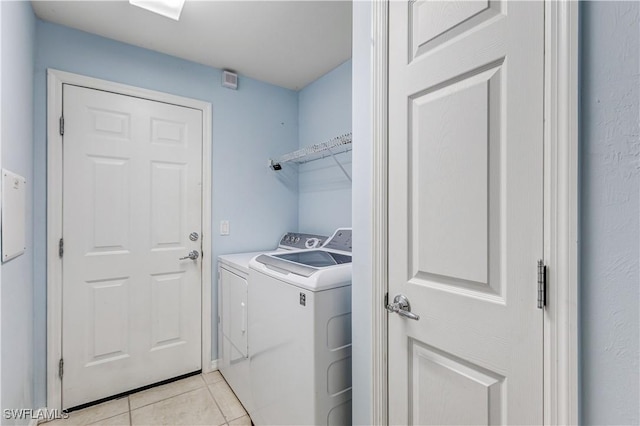2664 Astwood Ct, Cape Coral, FL 33991 - washroom with separate washer and dryer and light tile patterned flooring