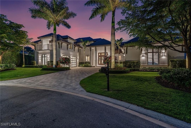 714 Killdeer Pl, Naples, FL 34108 - view of front of property with french doors, decorative driveway, a balcony, a front lawn, and stucco siding
