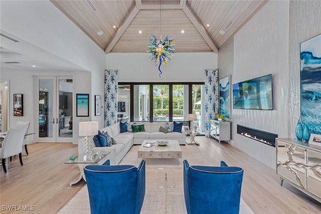 714 Killdeer Pl, Naples, FL 34108 - living area with high vaulted ceiling, wood finished floors, wood ceiling, a large fireplace, and french doors
