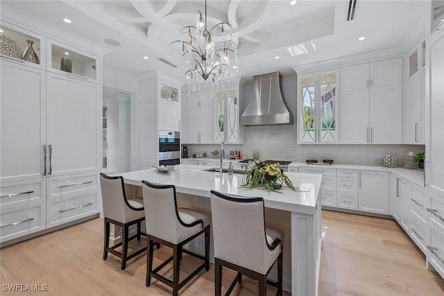 714 Killdeer Pl, Naples, FL 34108 - kitchen with wall chimney exhaust hood, light countertops, coffered ceiling, stainless steel oven, and recessed lighting