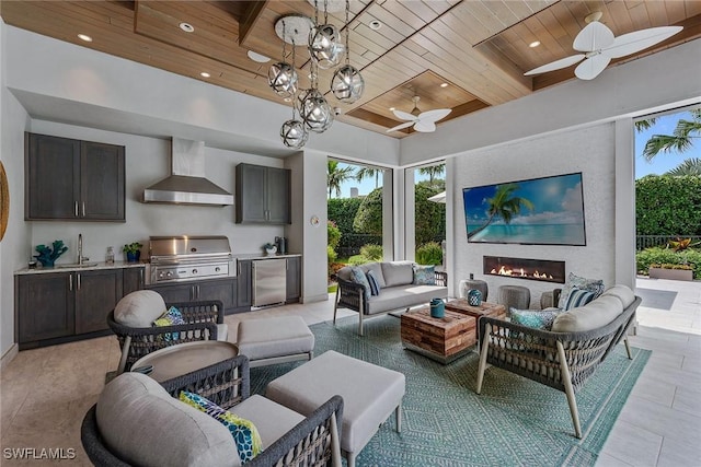 714 Killdeer Pl, Naples, FL 34108 - living room featuring wood ceiling, ceiling fan, a warm lit fireplace, light tile patterned floors, and recessed lighting
