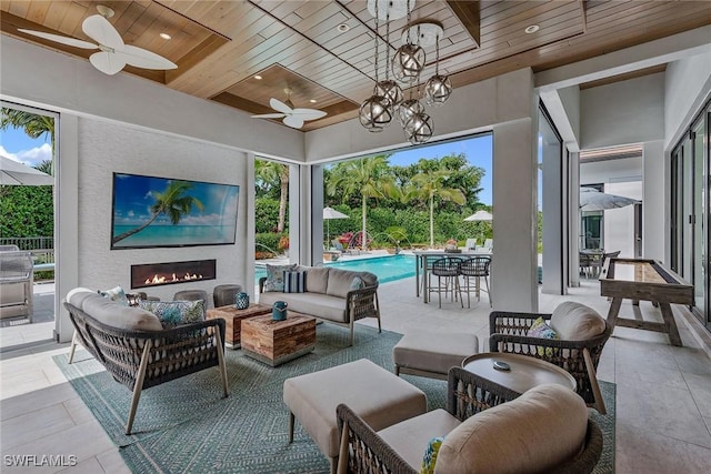 714 Killdeer Pl, Naples, FL 34108 - view of patio / terrace with an outdoor living space with a fireplace, ceiling fan, and an outdoor pool
