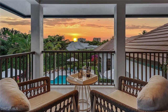 714 Killdeer Pl, Naples, FL 34108 - balcony at dusk featuring view of pool
