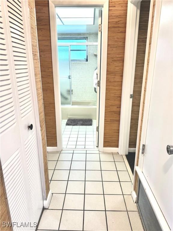 corridor with light tile patterned flooring