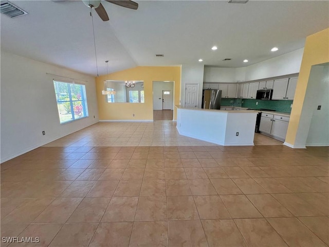 8000 Fountain Mist Blvd, Lehigh Acres, FL 33972 - kitchen with stainless steel appliances, open floor plan, lofted ceiling, a chandelier, and light tile patterned flooring