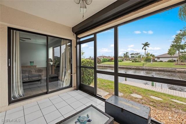 unfurnished sunroom featuring a water view