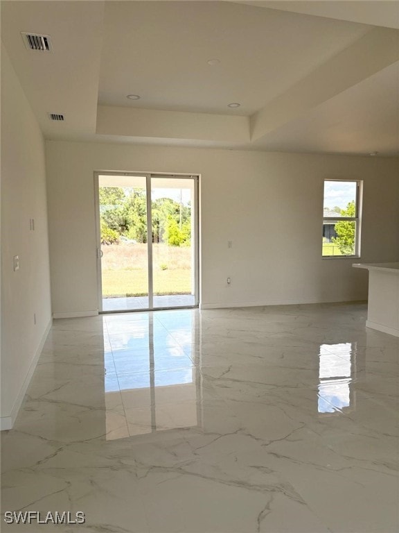 4118 4th St SW, Lehigh Acres, FL 33976 - unfurnished room featuring a raised ceiling, baseboards, and light marble finish floors