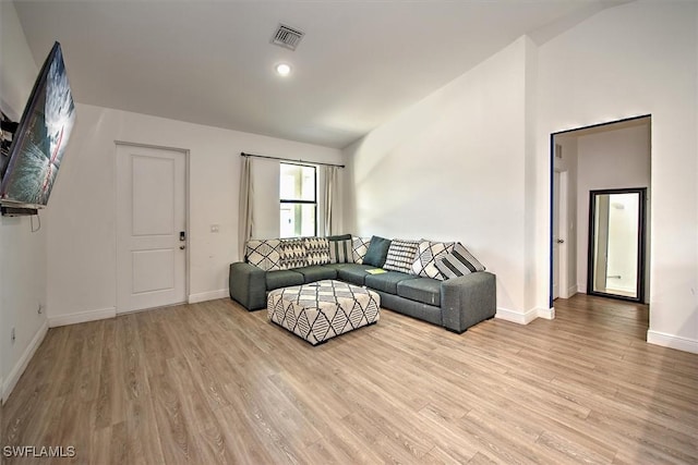 5007 W Hummingbird Dr, Labelle, FL 33935 - living area with light wood-type flooring, vaulted ceiling, and baseboards