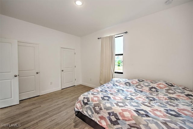5007 W Hummingbird Dr, Labelle, FL 33935 - bedroom featuring wood finished floors and baseboards