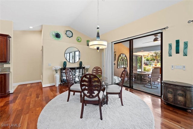 dining room featuring vaulted ceiling, wood finished floors, and baseboards