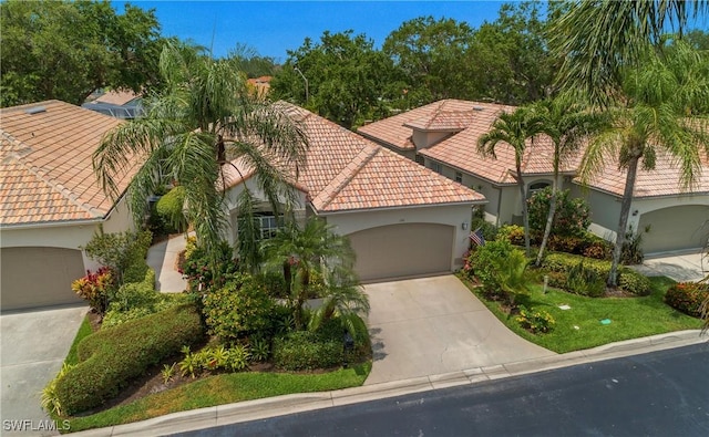 170 Vista Ln, Naples, FL 34119 - mediterranean / spanish house featuring a tile roof, concrete driveway, a garage, and stucco siding