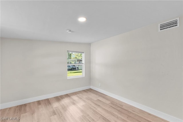 unfurnished room with light wood-style floors, baseboards, and recessed lighting