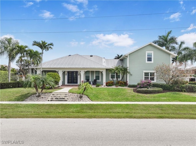 1767 Hummingbird Ct, Marco Island, FL 34145 - view of front of home featuring a front lawn and metal roof