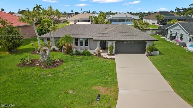 ranch-style home featuring an attached garage, driveway, a residential view, and a front yard