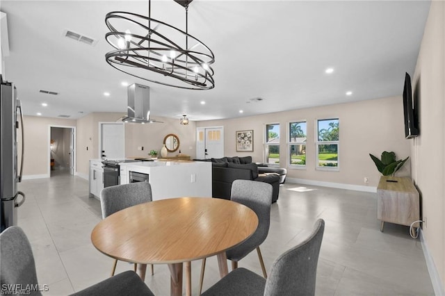 dining area featuring baseboards, recessed lighting, and a chandelier