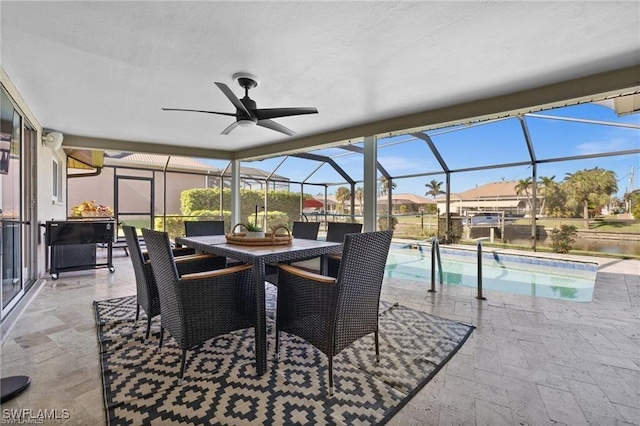swimming pool featuring a patio, a ceiling fan, a lanai, and outdoor dining space