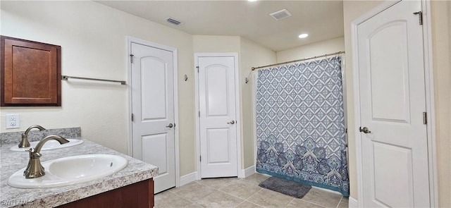 1948 Redmont Ave, Lehigh Acres, FL 33972 - full bath featuring tile patterned flooring, baseboards, double vanity, and curtained shower