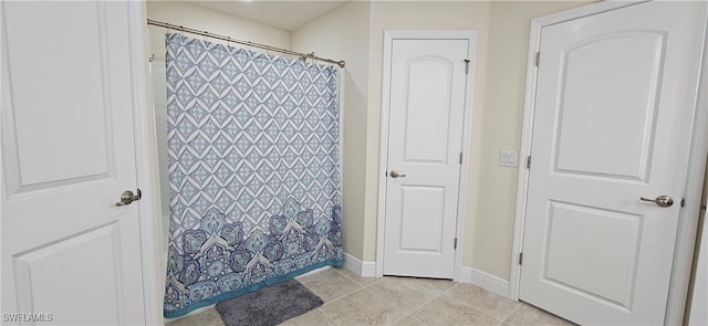 1948 Redmont Ave, Lehigh Acres, FL 33972 - bathroom with tile patterned flooring, baseboards, and curtained shower